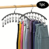 A set of 10 clip-style hangers for organizing pants in a closet.