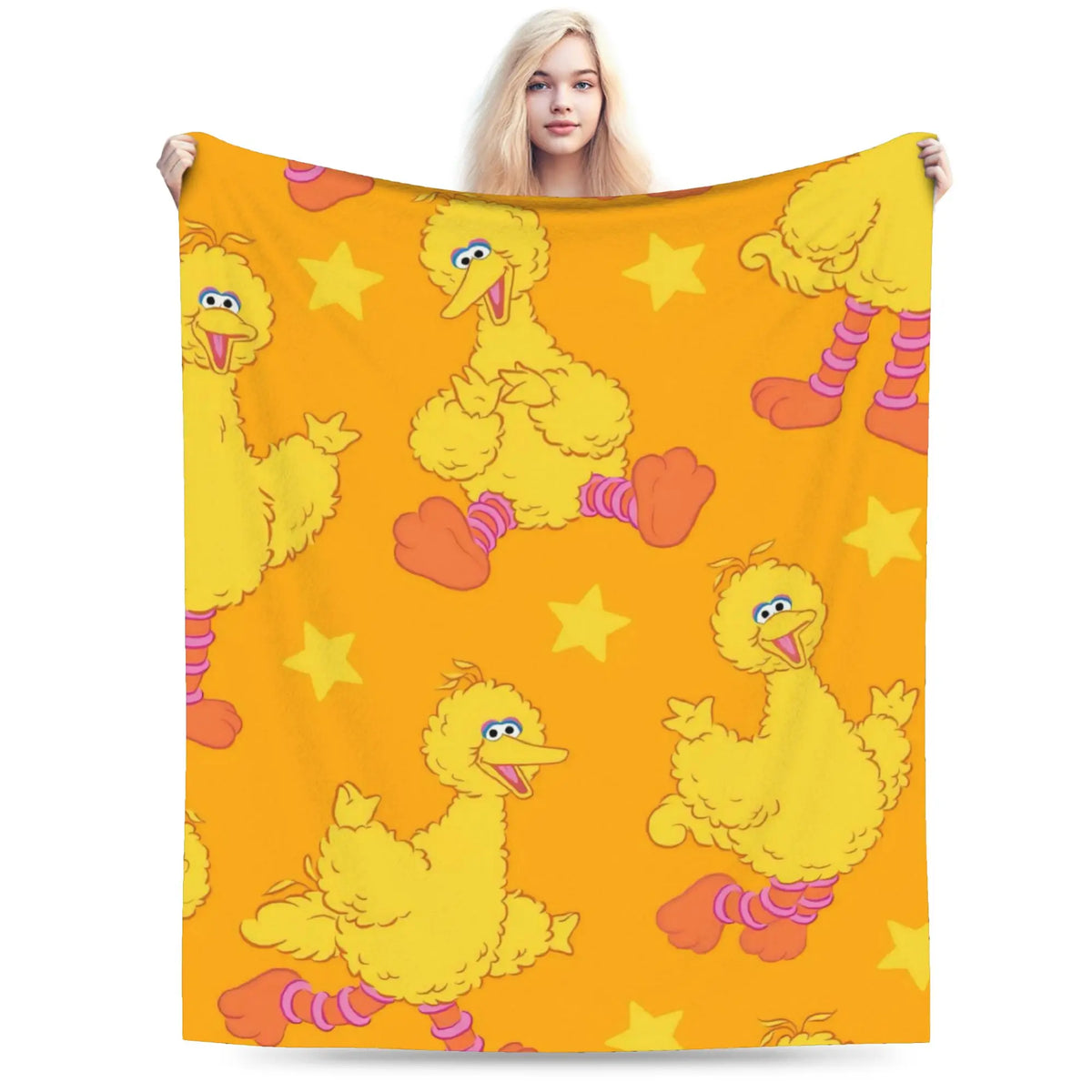 A yellow cartoon chick character design on a bright orange fabric throw blanket.