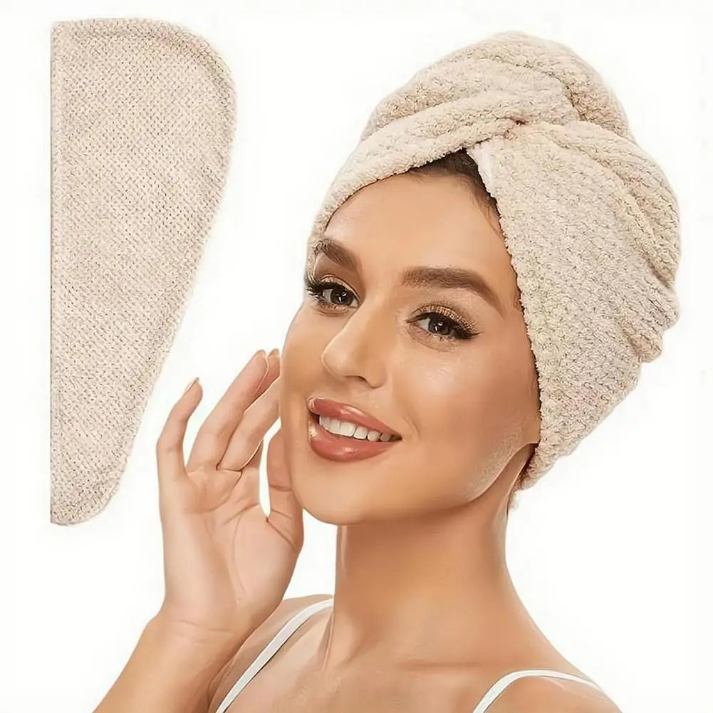 A woman is wearing a beige microfiber hair drying towel wrap on her head.