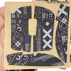 A close-up of a G Pro Wireless mouse grip tape featuring various patterns and designs on a beige background.