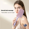 A woman is using a purple hair comb for a smooth hair massage on her scalp.