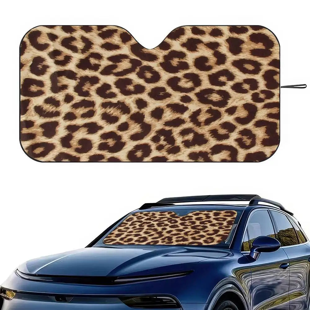 Leopard print car windshield sunshade placed on a blue car.