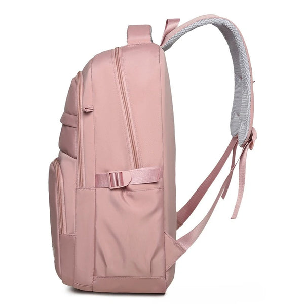 A light pink travel backpack with a padded laptop compartment and gray adjustable straps.