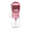 A pink and clear all-in-one portable pet water bottle with food storage container.