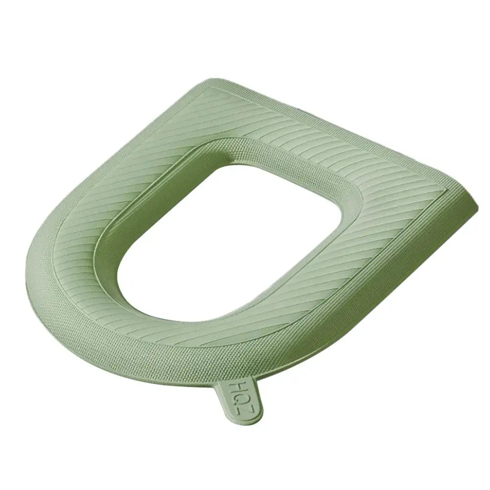 A light green, textured EVA toilet seat cover with a contoured shape.