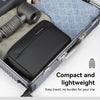 A black waterproof travel toiletry bag is shown inside an open suitcase with a black brush.