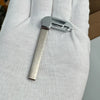 A close-up of a silver replacement remote key for Chevrolet and GMC vehicles held in a person's hand.