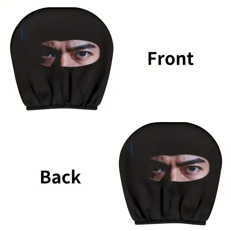A set of two black eye print car headrest covers shown from the front and back views.