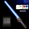 A bronze glowing musical toy sword with a telescoping blade and various colored lights shown against a dark background.