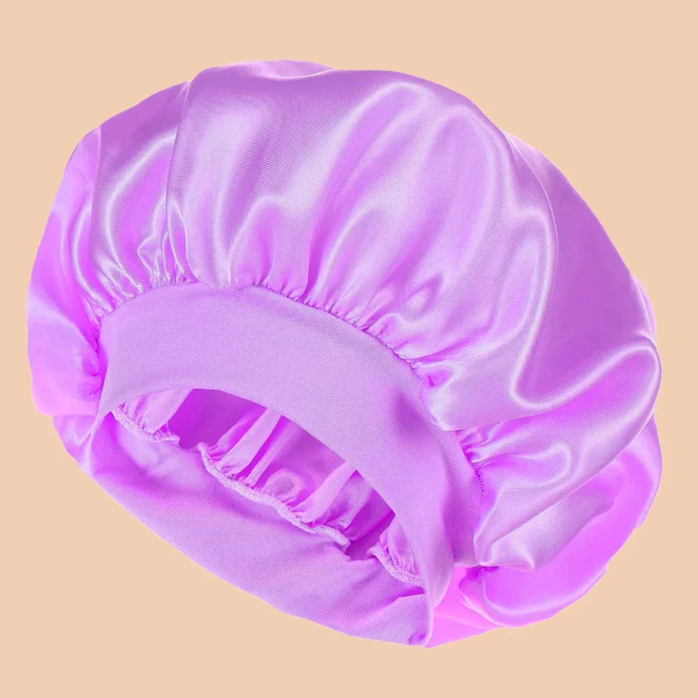 A vibrant purple satin wide brim shower cap is shown in a soft, draped style.