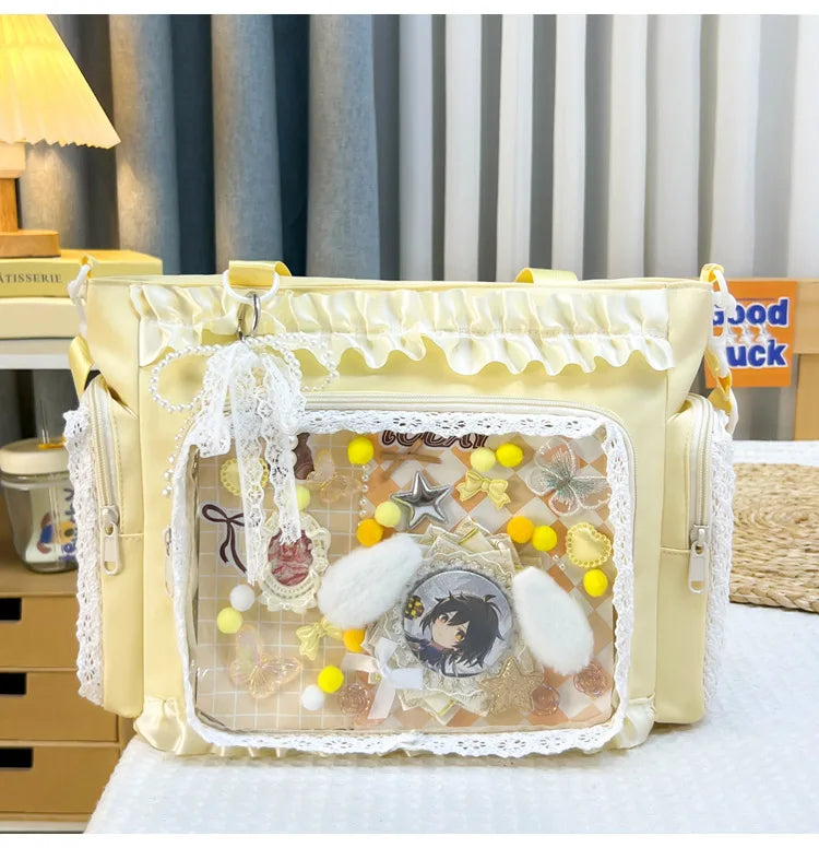 A yellow transparent shoulder bag with white lace trim and decorative elements is displayed on a white surface.