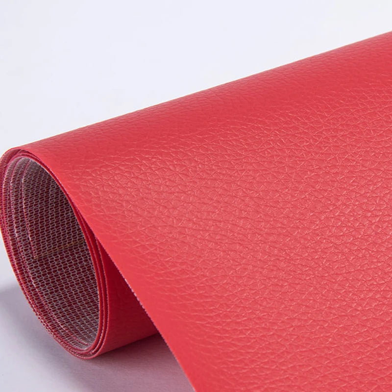 A roll of red self-adhesive PU leather repair patches, showing the textured surface and rolled edge.