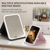 A portable touch vanity mirror with customizable LED lights shown next to a larger mirror and cosmetic products.