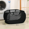 Black folding mesh laundry basket with handles shown on a wooden floor.