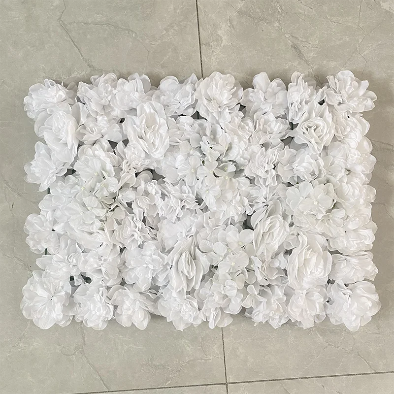 A rectangular wall panel covered entirely in white silk rose flowers.