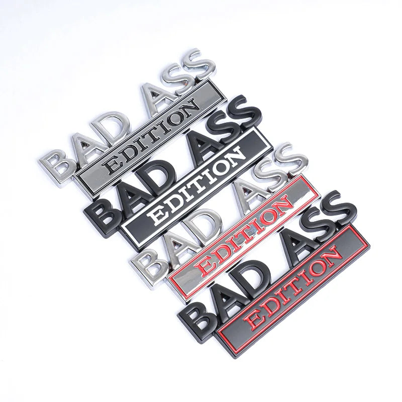A collection of silver, black, and red 3D metal badge emblems with the text BAD ASS EDITION.