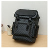 A black faux leather backpack with a checkered pattern and black accents resting on a wooden surface.