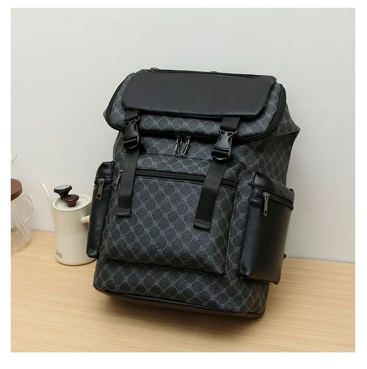 A black faux leather backpack with a checkered pattern and black accents resting on a wooden surface.