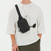A person wearing a white t-shirt displays a black 2-in-1 convertible waist and crossbody sling bag.