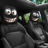 A pair of quirky car headrest covers with exaggerated eyes are shown inside a dark vehicle interior.