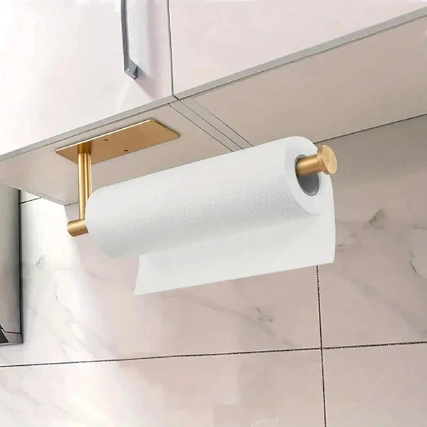 A white paper towel roll is mounted on a stainless steel wall rack above a kitchen cabinet.