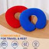 Two inflatable U-shaped neck pillows in red and blue resting on a wooden surface, shown with travel icons.