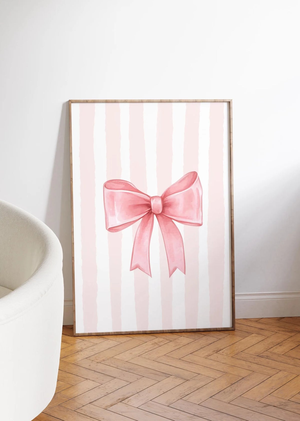 A framed canvas print featuring pink and white vertical stripes with a large pink bow design.
