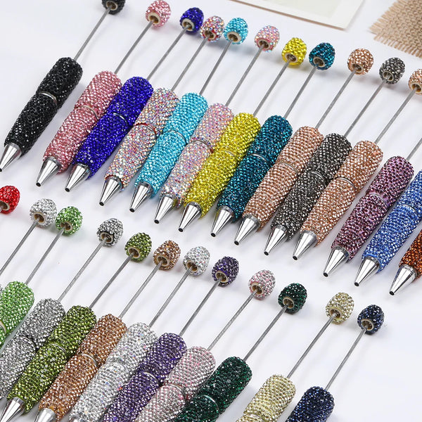 A collection of decorative beaded pens and needles for DIY jewelry making