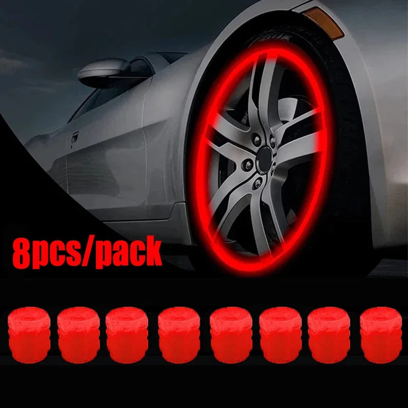 A close-up of a car wheel with a red glowing ring, next to eight red tire valve caps.