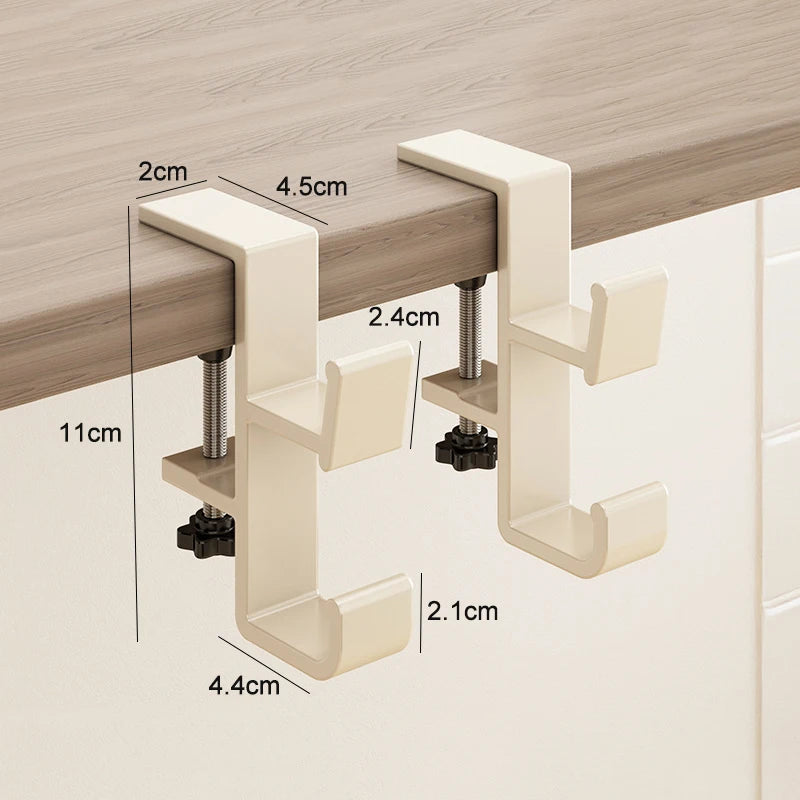 A beige foldable aluminum desk hook with various sized brackets and mounting hardware shown against a wooden surface.