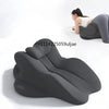 A dark gray ergonomic memory foam reading pillow is shown being used by a woman in a relaxed posture.