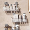 Wall-mounted storage basket with a water ripple design holding various bottles and cans.
