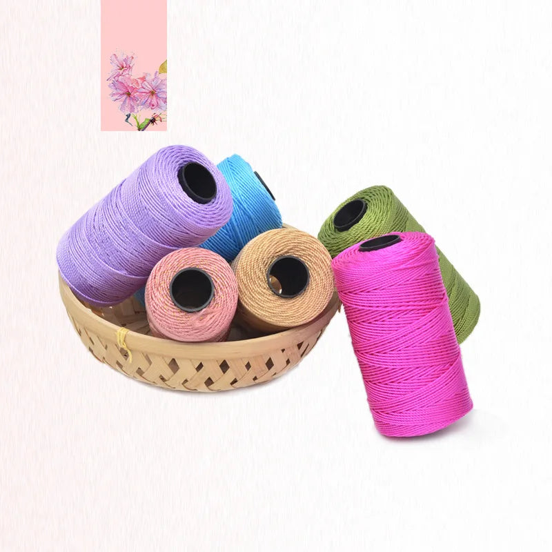 A collection of colorful 3-ply polyester knitting yarn spools in shades of purple, blue, pink, and green resting in a woven b