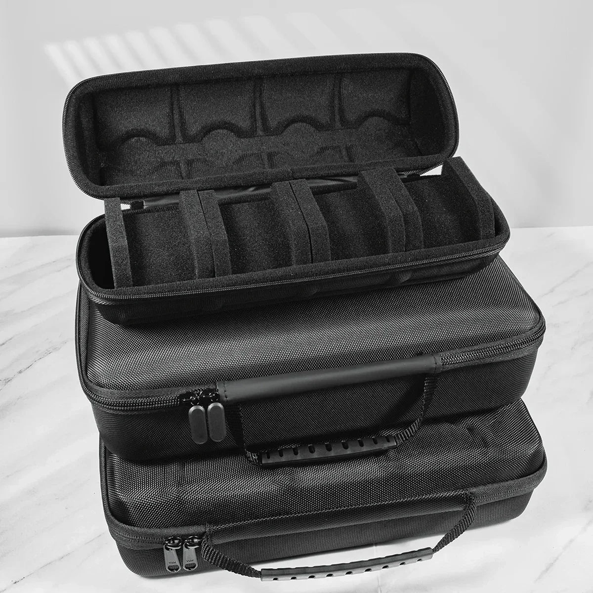 A black portable leather watch travel case with a soft lining shown stacked on a white surface.
