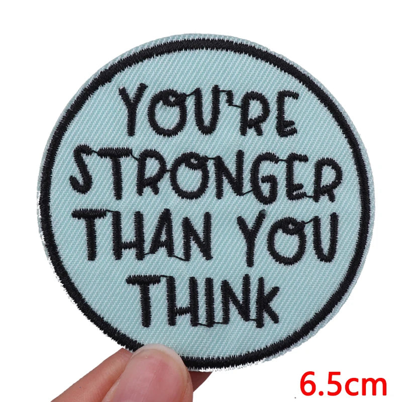 A light blue embroidered patch with black text that reads You're stronger than you think.