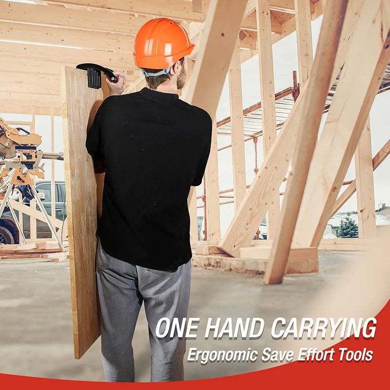A construction worker in a black shirt is using a one-hand carrying tool to install wood paneling inside a framed structure.