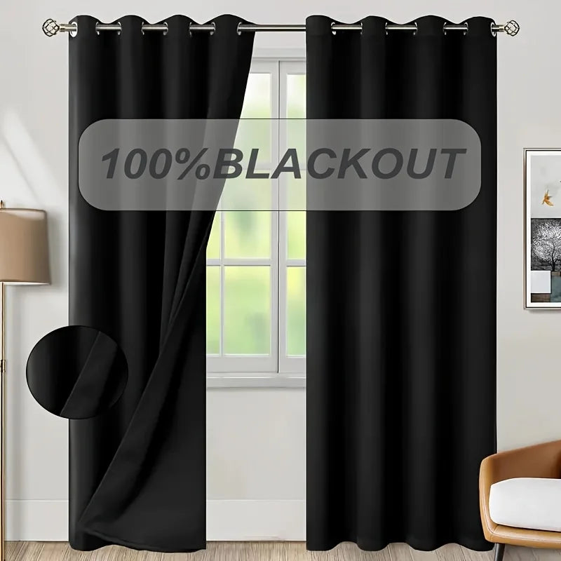 A black blackout curtain panel hanging in a window frame.