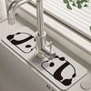 A modern chrome faucet mounted on a white mat, featuring a floral design.