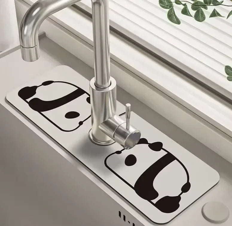 A modern chrome faucet mounted on a white mat, featuring a floral design.