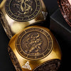 A pair of gold metal spinner dice cubes for Dungeons and Dragons displayed on a dark surface.