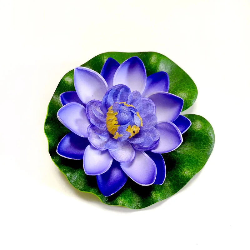 A vibrant purple and blue lotus flower with green leaves floating on white.