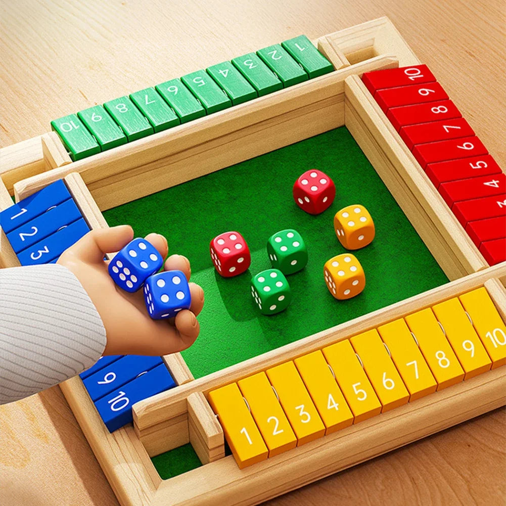 A wooden box game featuring colored dice arranged in slots, with a hand holding blue dice.
