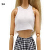 A fashion doll wearing a white cropped tank top and a black and white plaid skirt.