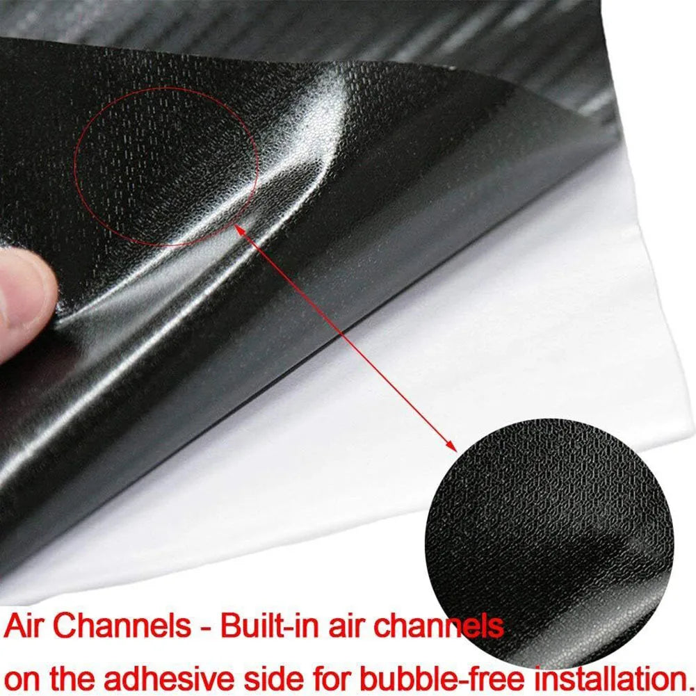 High-gloss black vinyl wrap strip showing built-in air channels on the adhesive side for bubble-free installation.