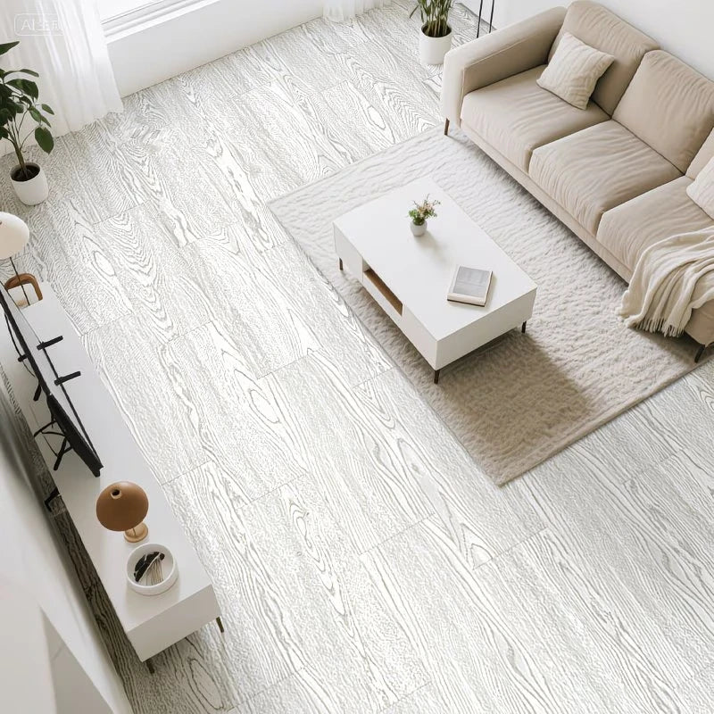 A bright, modern living room featuring light wood grain floor tiles, a beige sofa, and a white coffee table.