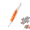 A white and orange automatic diamond painting bead dispensing pen with a precision tip being held by a hand.