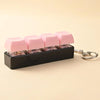 A black keychain holder filled with pink LED mechanical fidget toys.