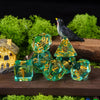 A set of adorable animal resin dice, including a black bird figurine and various colored dice, resting on a wooden surface wi