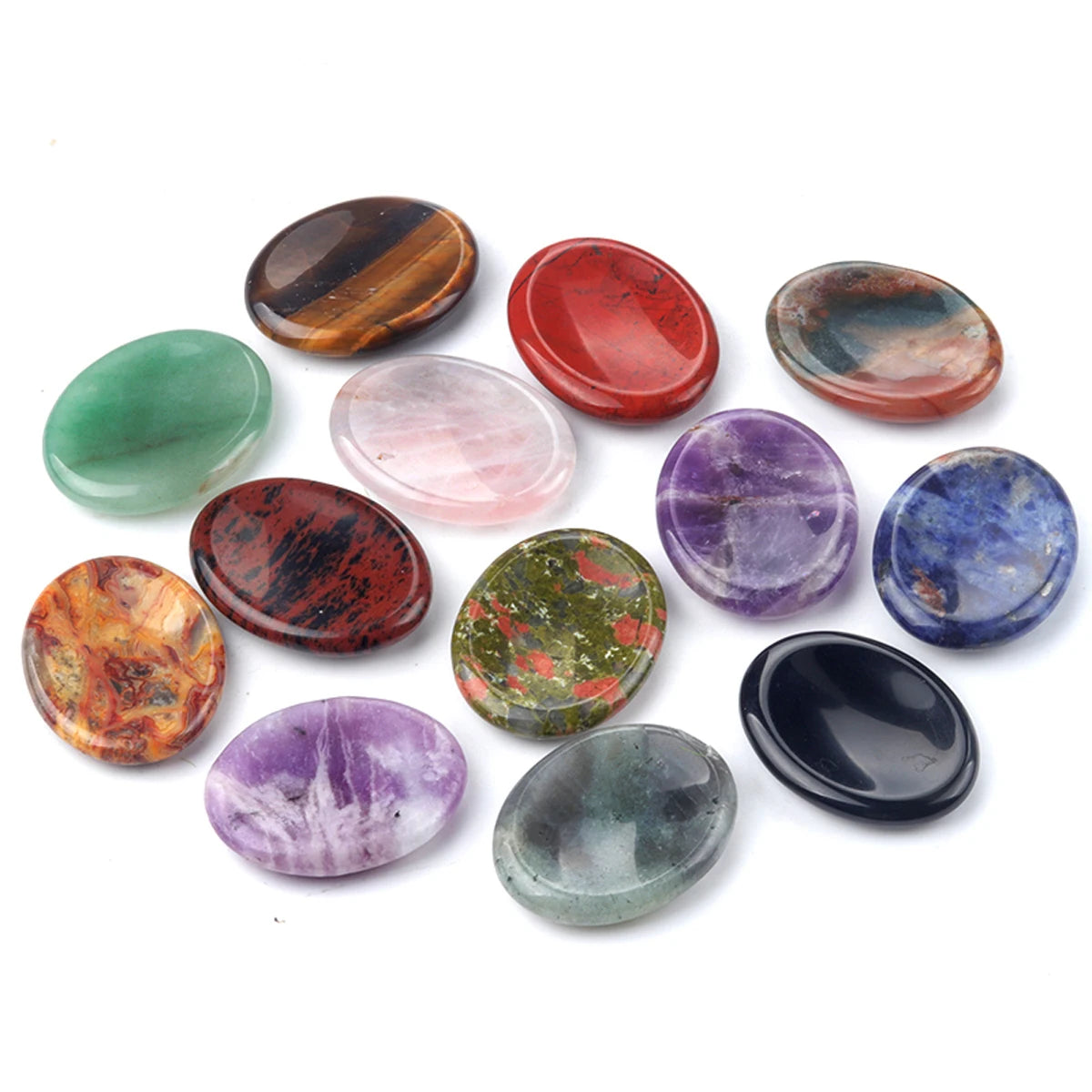 A collection of oval natural crystal stones in various colors including red, green, purple, and brown.
