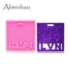 A pink silicone resin mold with a purple glitter background, used for making badge backings and keychains.